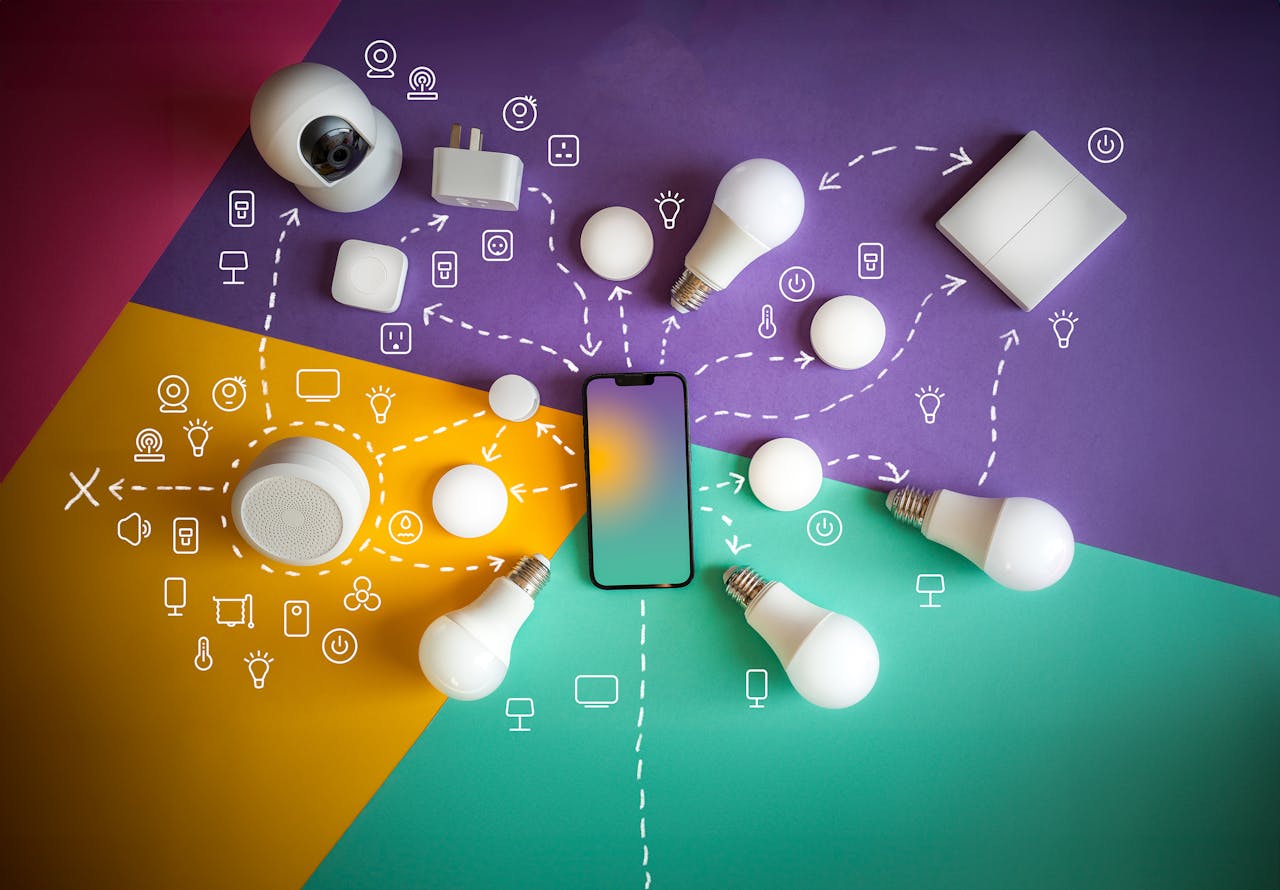 Flat lay of smart home devices and smartphone showcasing automation and connectivity.