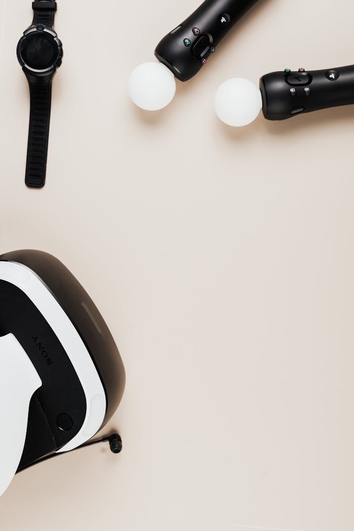 Top view of virtual reality headset and smartwatch on beige surface. Ideal for tech themes.